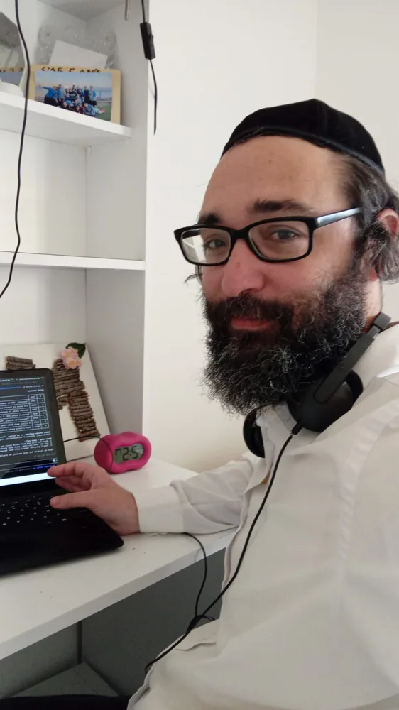 Zechariah Tokar at his desk beside his laptop